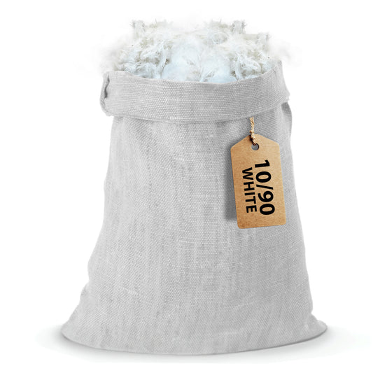A stack of 10/90 white down pillows rests inside a gray canvas bag, distinguished by a brown tag